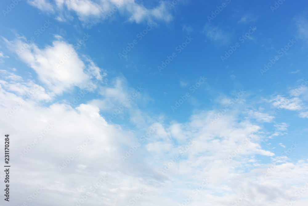 Blue sky background and white clouds soft focus, and copy space