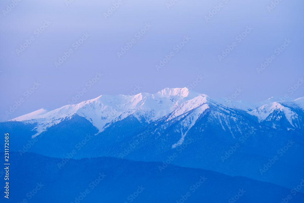 Winter background with a snowy mountain peak