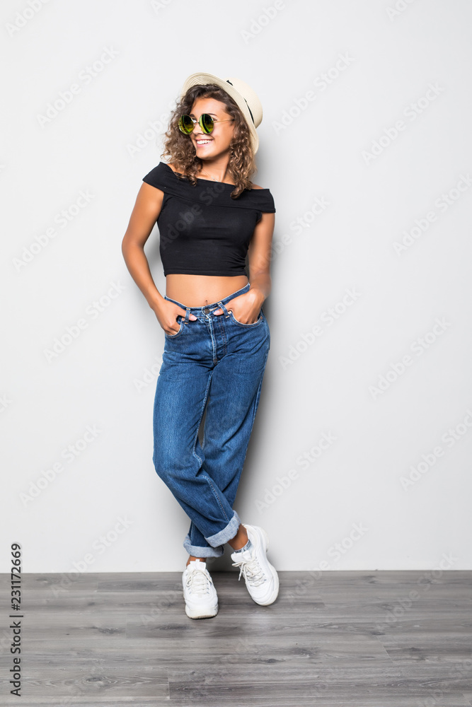 Full length portrait of beautiful american woman wearing jeans and t-shirt  posing on camera with candid smile and hand in pocket isolated over white  background Photos | Adobe Stock