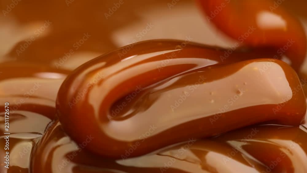  Caramel dripping thick strand. Slow motion.