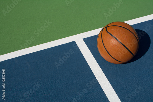 Basketball rests on court