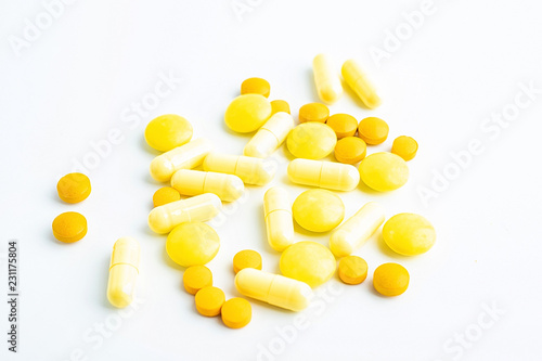 Yellow pill on white background