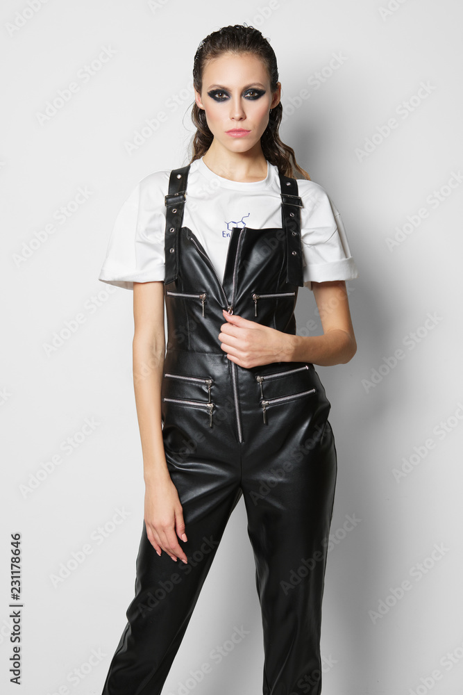 Girl in faux leather overalls and t 