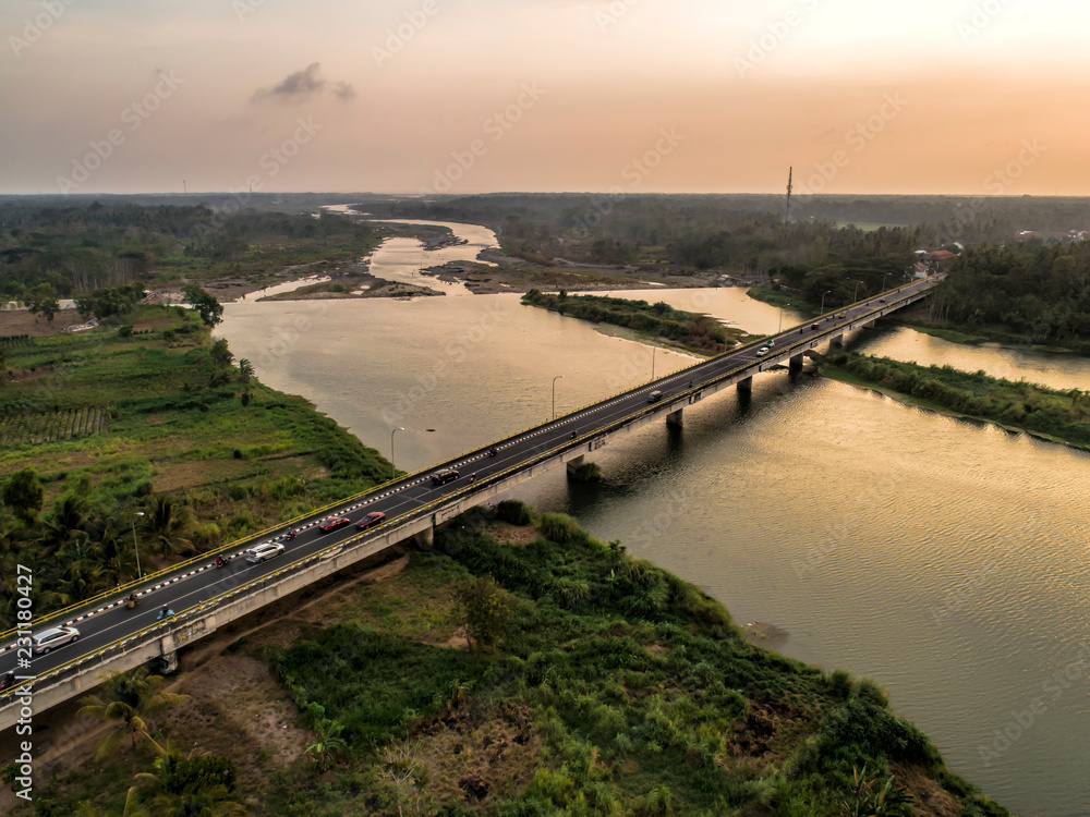Long bridge aerial view of photo crossing wide river