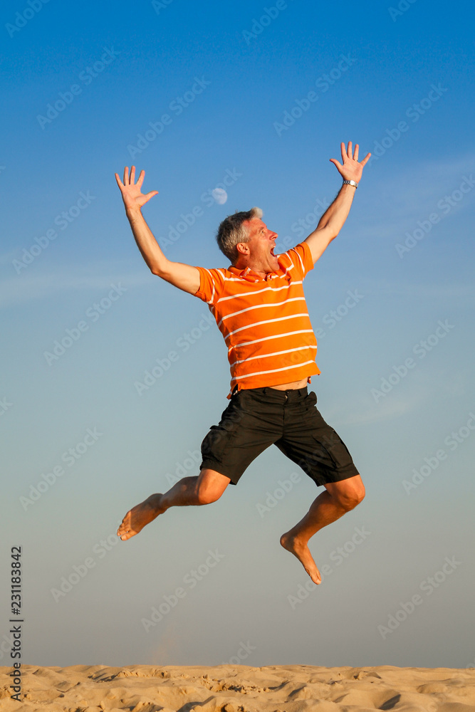 young man jumping on background of blue sky young man jumping on background of blue sky