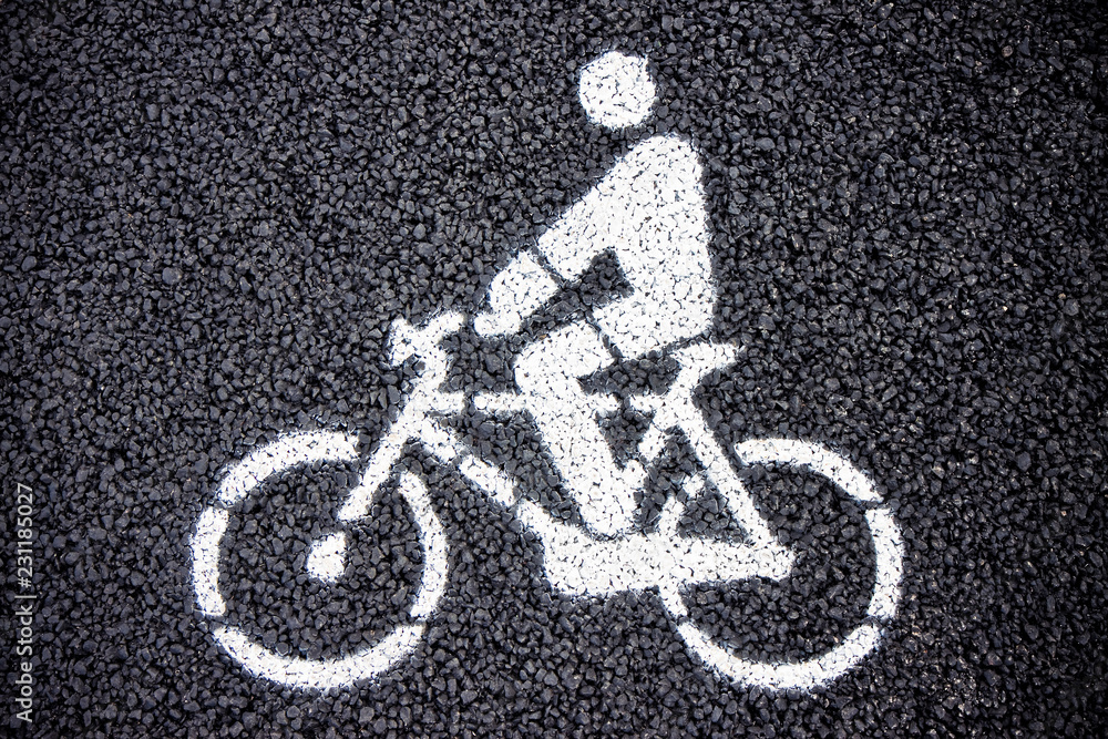 Bicycle road sign on black tarmac Bicycle road sign on black tarmac