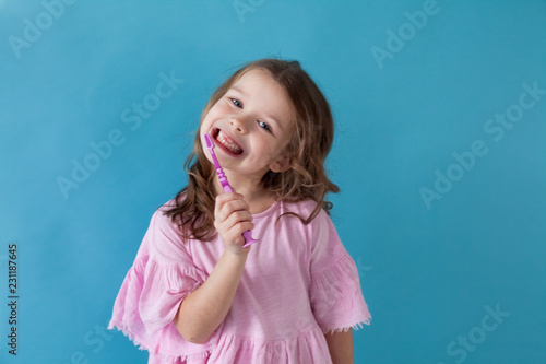 little girl with a toothbrush in dentistry nice