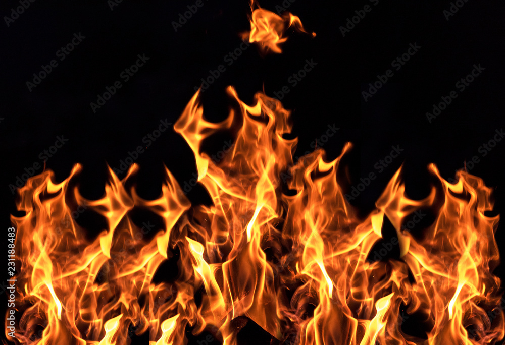 burning orange flame on black background burning orange flame on black background