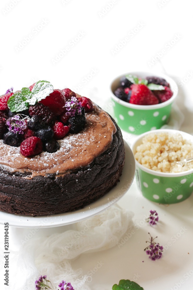 Homemade Chocolate Quinoa Cake topped with fruits and berries