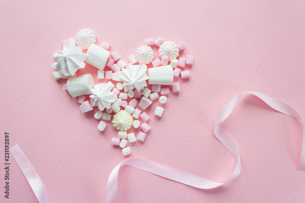 various pastel marshmallows in the heart shape on pink background various pastel marshmallows in the heart shape on pink background