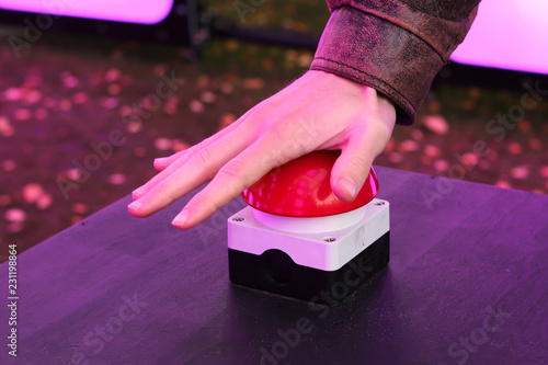 Hand pressing red button, concept of decision making, taking charge, starting something
