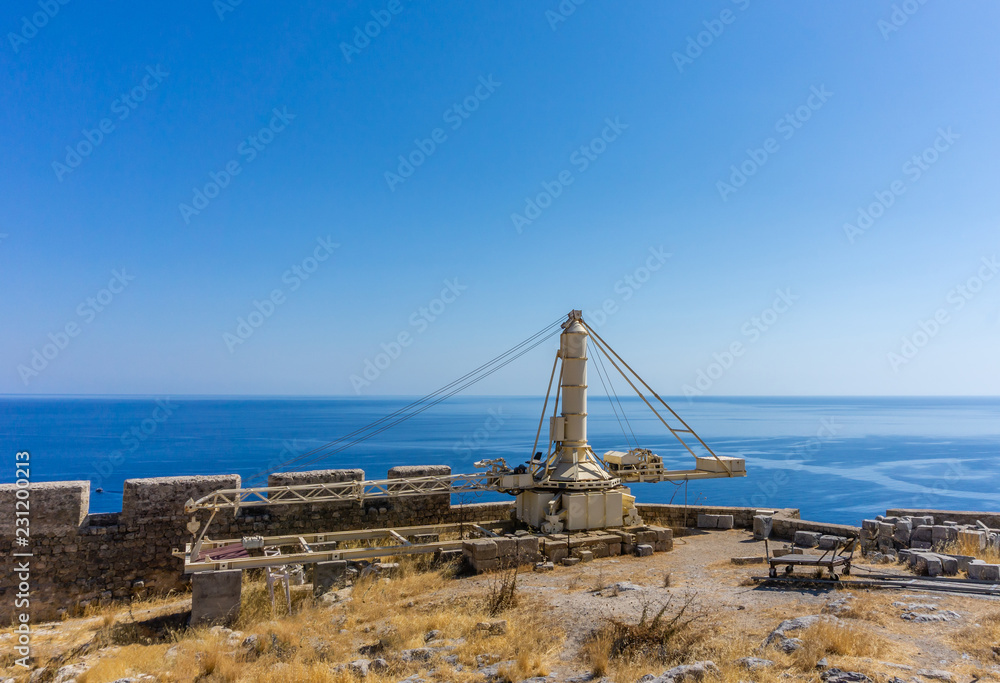 Old heavy crane on the top of Acropolis above ancient town Lindos on Rhodes island