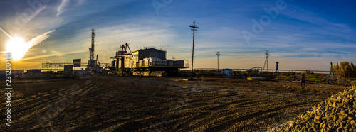 Construction site of a drilling rig at sunset panorama