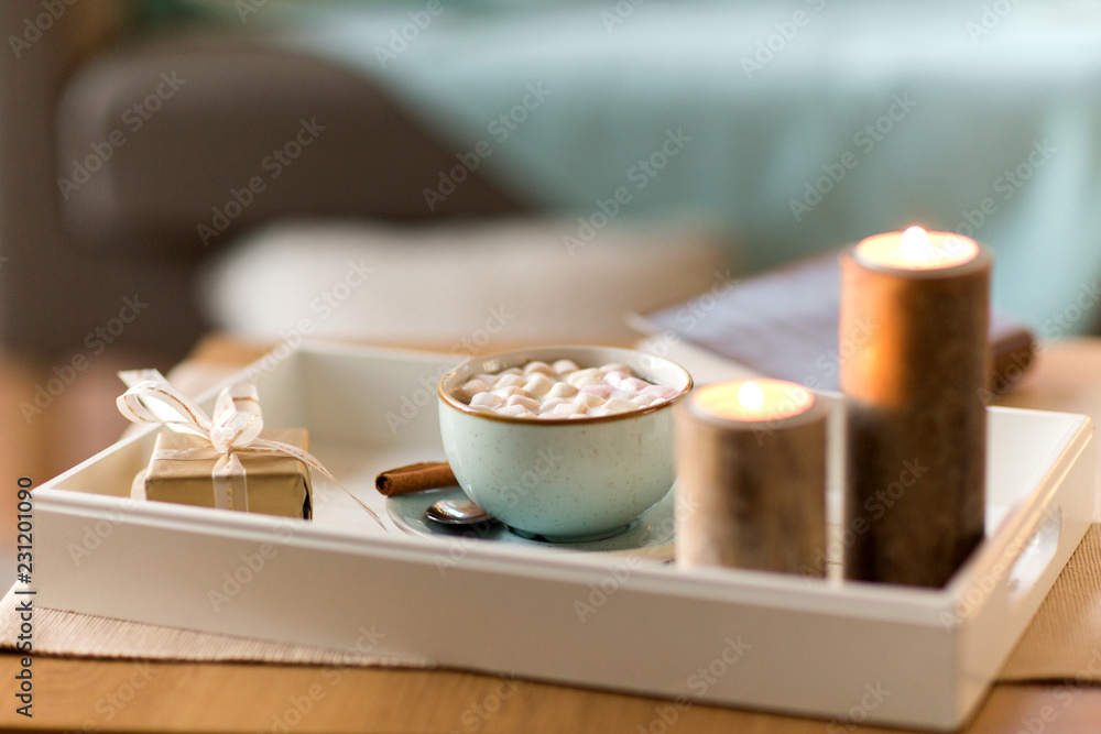 holidays and still life concept - hot chocolate with marshmallow, christmas gift and candles on table holidays and still life concept - hot chocolate with marshmallow, christmas gift and candles on table