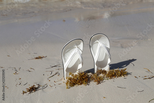 White sandals. White sandals on the beach. photo