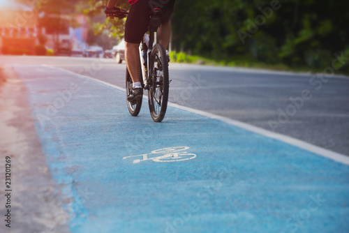 People are cycling on highways with dedicated bicycle lanes and soft light from the front, safe driving, cyclists on bike trails, Cycling for health, Exercise with cycling, Bike, Bycicle.