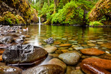 Punch Bowl Falls along the Eagle Creek Trail in Oregon with focus on the rocks in the foreground