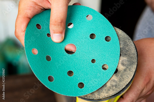 Close-up of hands holding emery circles for grinding machines,