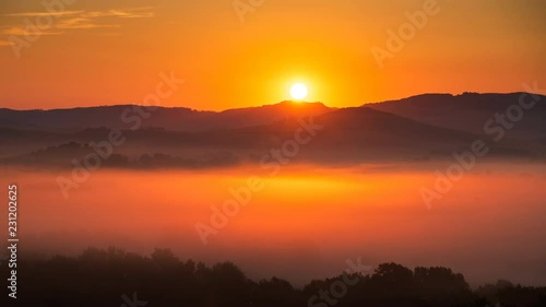 4K Time lapse of sunrise at misty morning, Tuscany, Italy photo