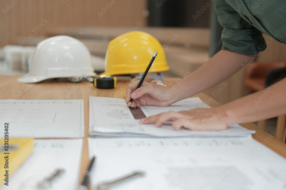 architect engineer working on house blueprint of real estate project at workplace. building construction concept architect engineer working on house blueprint of real estate project at workplace. building construction concept