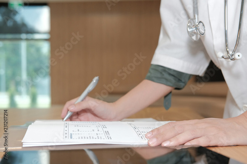 physician doctor write medical examination or prescription note at hospital. practitioner fill patient information at clinic