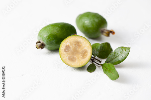 Fresh raw feijoa fruit on white concrete background photo