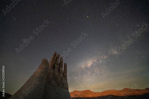 The amazing Mano del Desierto (Desert Hand) with a Milky Way in the southern hemisphere and the Magellan Clouds galaxies with millions of stars around the night sky just amazing. Chile Nightskies
 photo