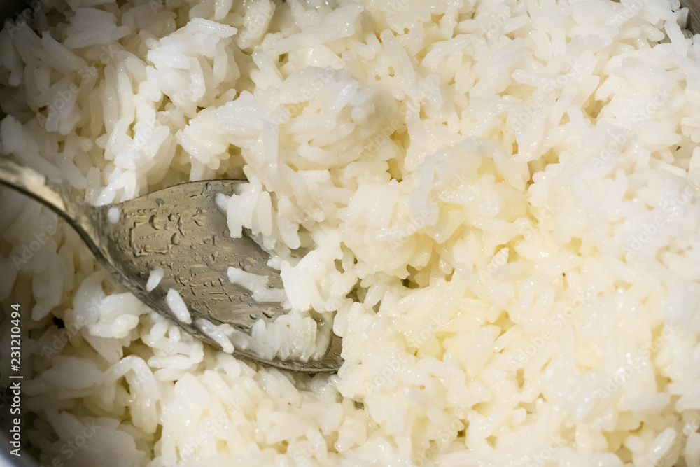 top view of spoon in a pan with boiled rice top view of spoon in a pan with boiled rice