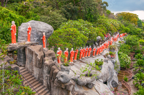 Procession of sculptured Buddhist monks Dambulla Caves Cultural Triangle Sri Lanka. photo