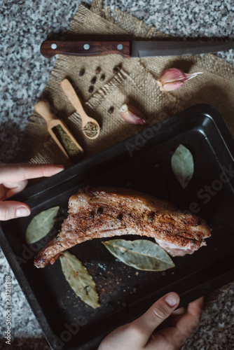 raw meat on in a metal box on dark background. cook cookes the meat