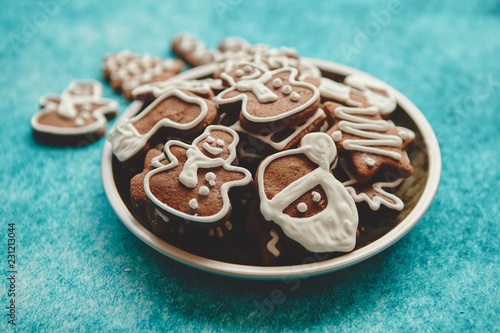 Rustical plate filled with delicous, varous Christmas shaped gingerbread cookies. Top view. Placed on blue rustic background. photo