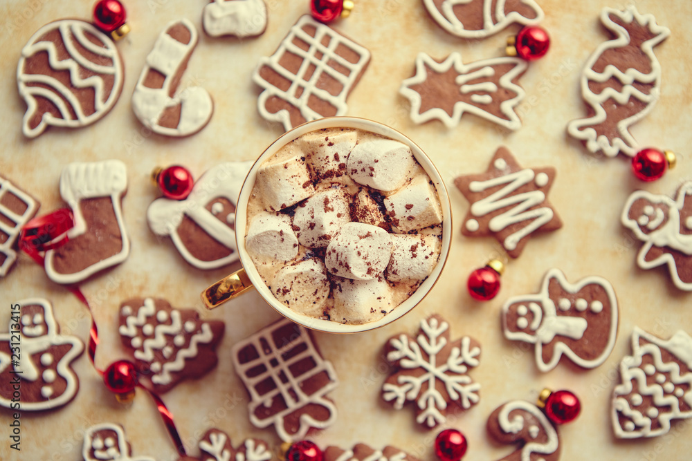 Cup of hot chocolate with tasety marshmellows. Fresh baked Christmas shaped gingerbread cookies on sides. With Xmas decorations. View from above. Cup of hot chocolate with tasety marshmellows. Fresh baked Christmas shaped gingerbread cookies on sides. With Xmas decorations. View from above.