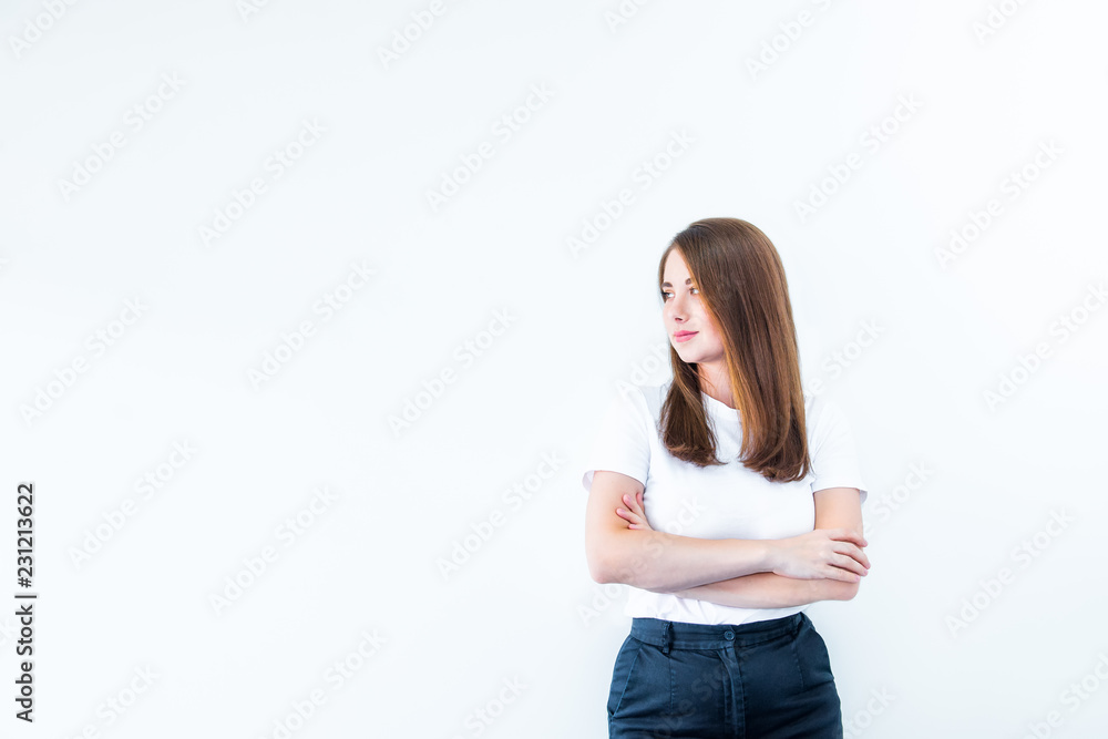 Portrait of smiling confident young caucasian woman standing with crossed or folded arms and looking away at copy space isolated over white background. Selective focus, copy space. Portrait of smiling confident young caucasian woman standing with crossed or folded arms and looking away at copy space isolated over white background. Selective focus, copy space.
