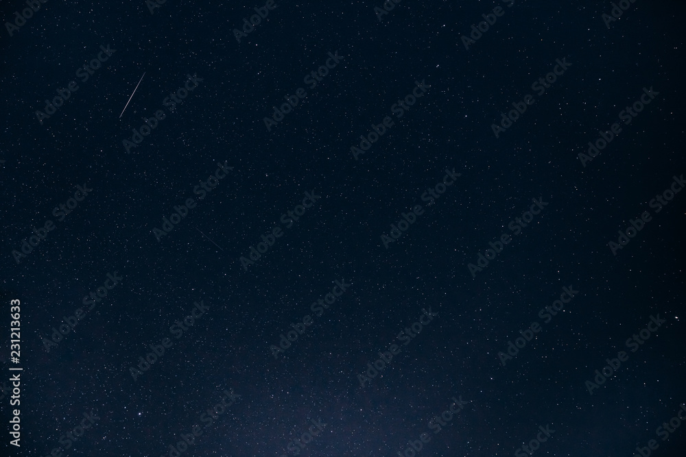 Fototapeta premium Night Starry Sky. Glowing Stars And Meteoric Tracks Trail In Dar