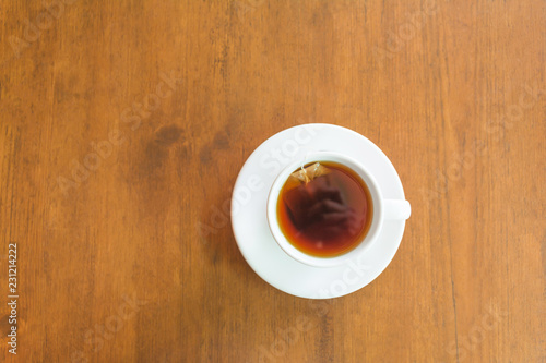 Top view and closeup of hot tea cup on a wooden table and copy space.