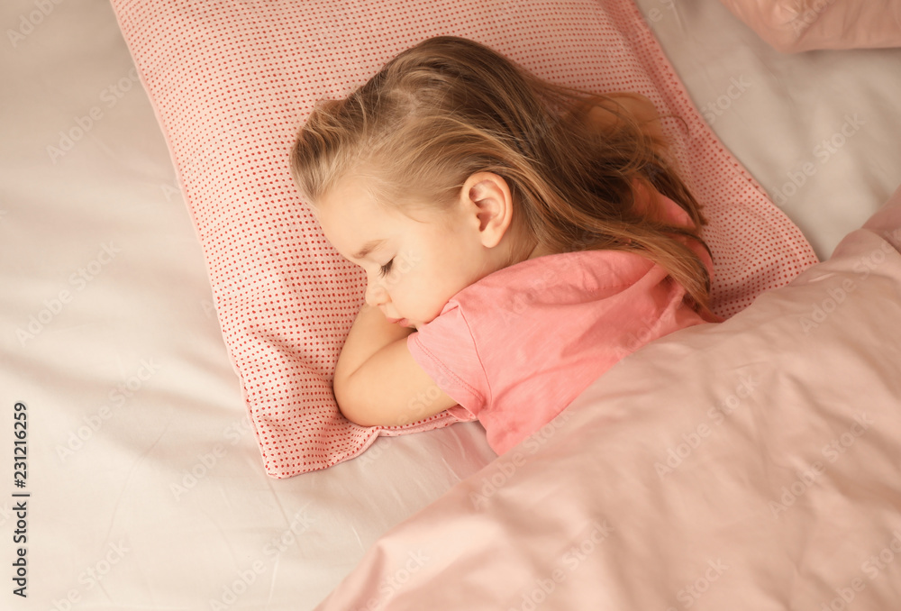 Cute little girl sleeping in bed at home