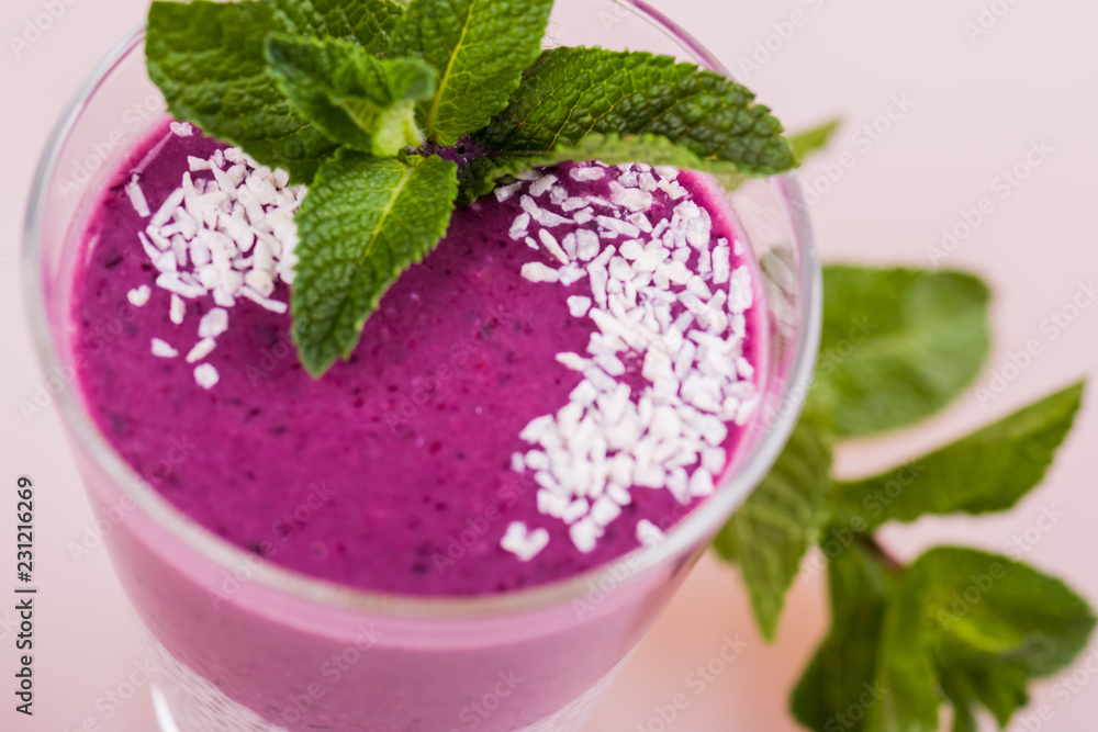Raspberry white pudding in a glass close-up. Purple dessert with chia seeds and coconut Raspberry white pudding in a glass close-up. Purple dessert with chia seeds and coconut