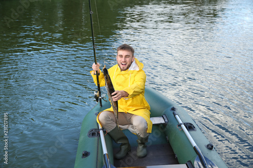 Man with rod fishing from boat. Recreational activity