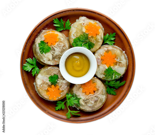 Aspic jellied meat with vegetables on plate top view isolated on white background