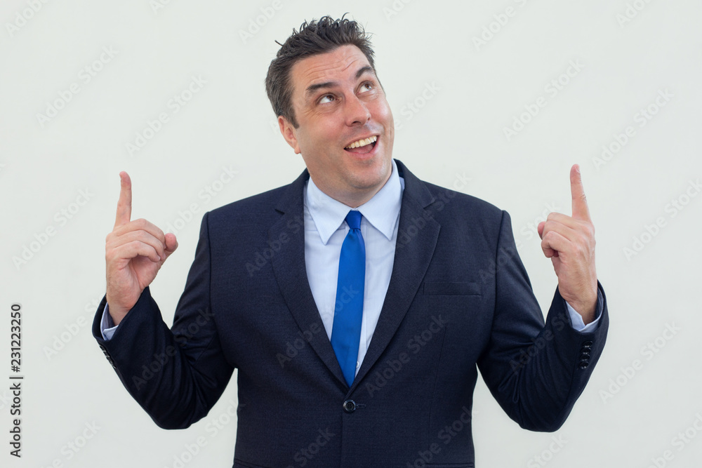 Happy excited businessman pointing up while making advertisement. Cheerful creative executive gesturing hands. Promotion concept Happy excited businessman pointing up while making advertisement. Cheerful creative executive gesturing hands. Promotion concept