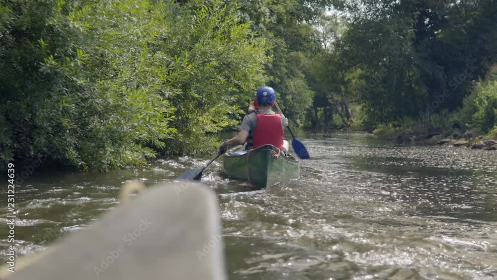 Canoeing adventure following a twin canoe down the river Canoeing adventure following a twin canoe down the river