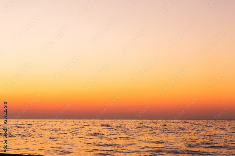Beautiful orange sunset on the sea. Evening landscape