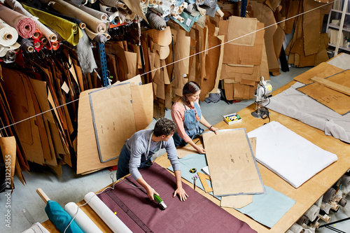 Colleagues Working At Workbench In Sofa Workshop photo