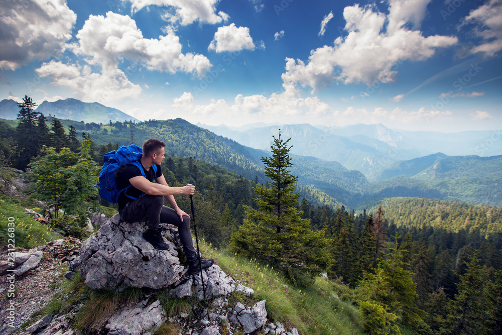 Male hiker with backpack enjoying at breathtaking view