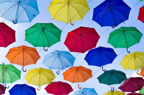 many bright umbrellas against the sky