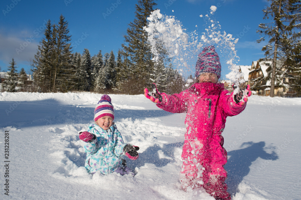 happy girls playing in the snow