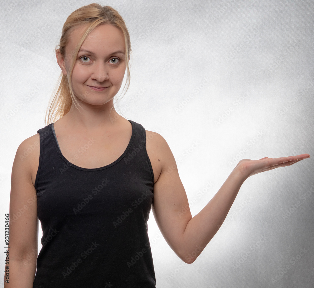 Fototapeta premium young woman in black tank top with open hand
