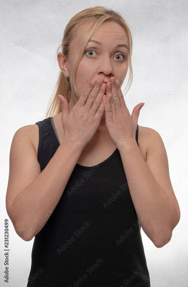 young woman covering mouth with her hands