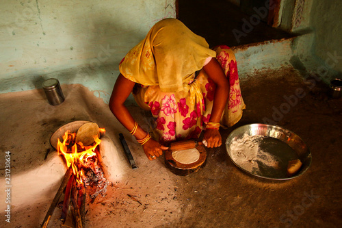 Traditional way of making food cooking on open fire in a rural village,near Kajiraho,India