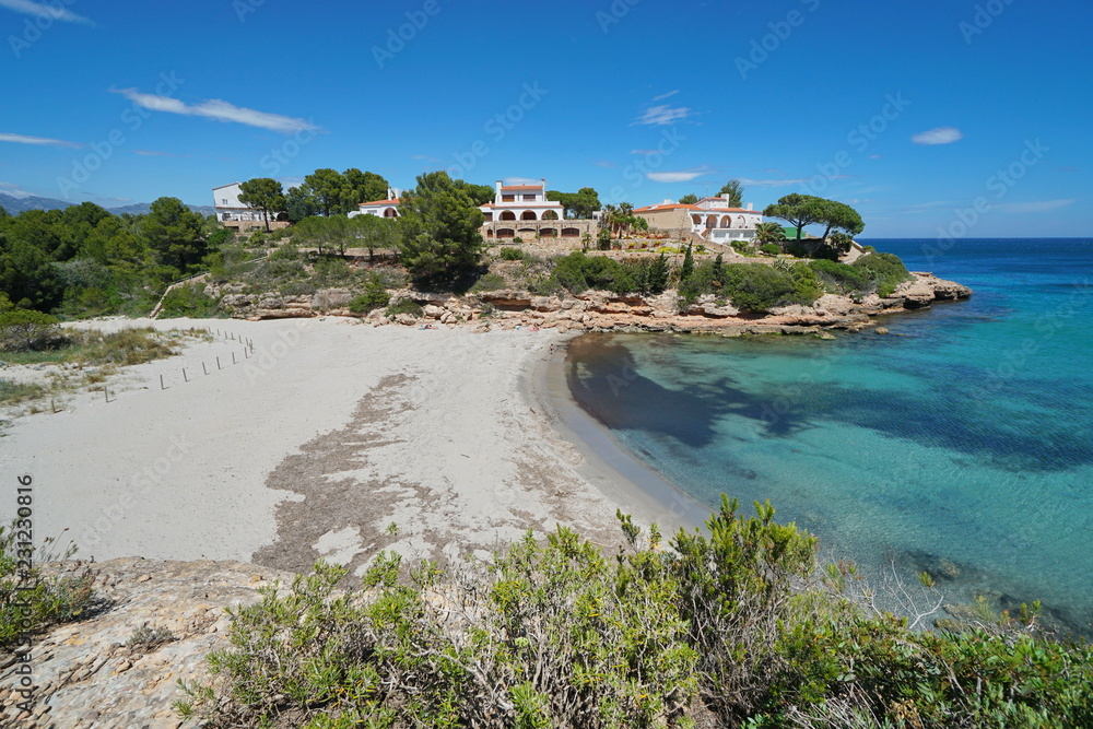 Spain peaceful sandy beach with coastal houses on the Costa Dorada, Cala Estany Tort, Mediterranean sea, Catalonia, L'Ametlla de Mar, Tarragona